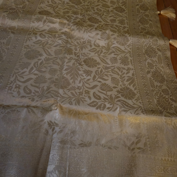 Cream Banarasi Silk Saree with Subtle Golden Zari & Tassel Detailing