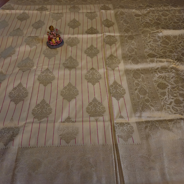 Cream Banarasi Silk Saree with Subtle Golden Zari & Tassel Detailing
